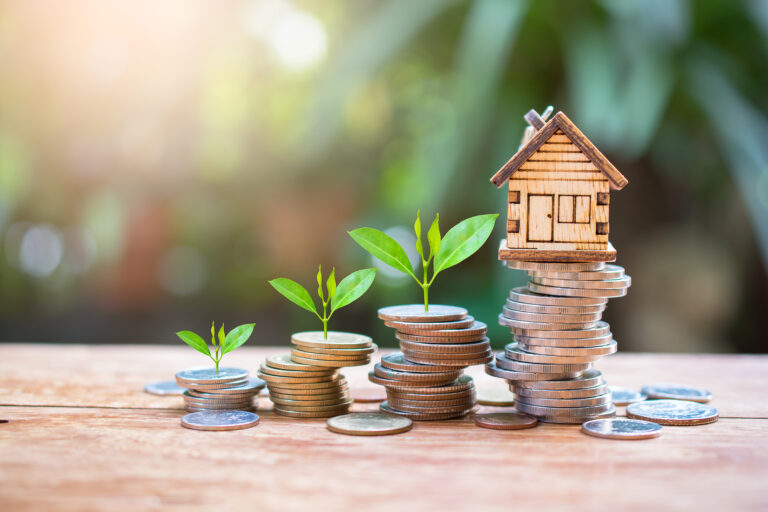house model on money coins saving for concept investment mortgag